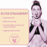 A promotional image for Glyde Ultra Strawberry Flavored Condoms 🍓 showcases a woman in a black top playfully holding a strawberry lollipop. The text emphasizes key features: standard fit, silky & strong, sustainably produced natural latex, lightly lubricated, and ultra-thin for enhanced sensation.